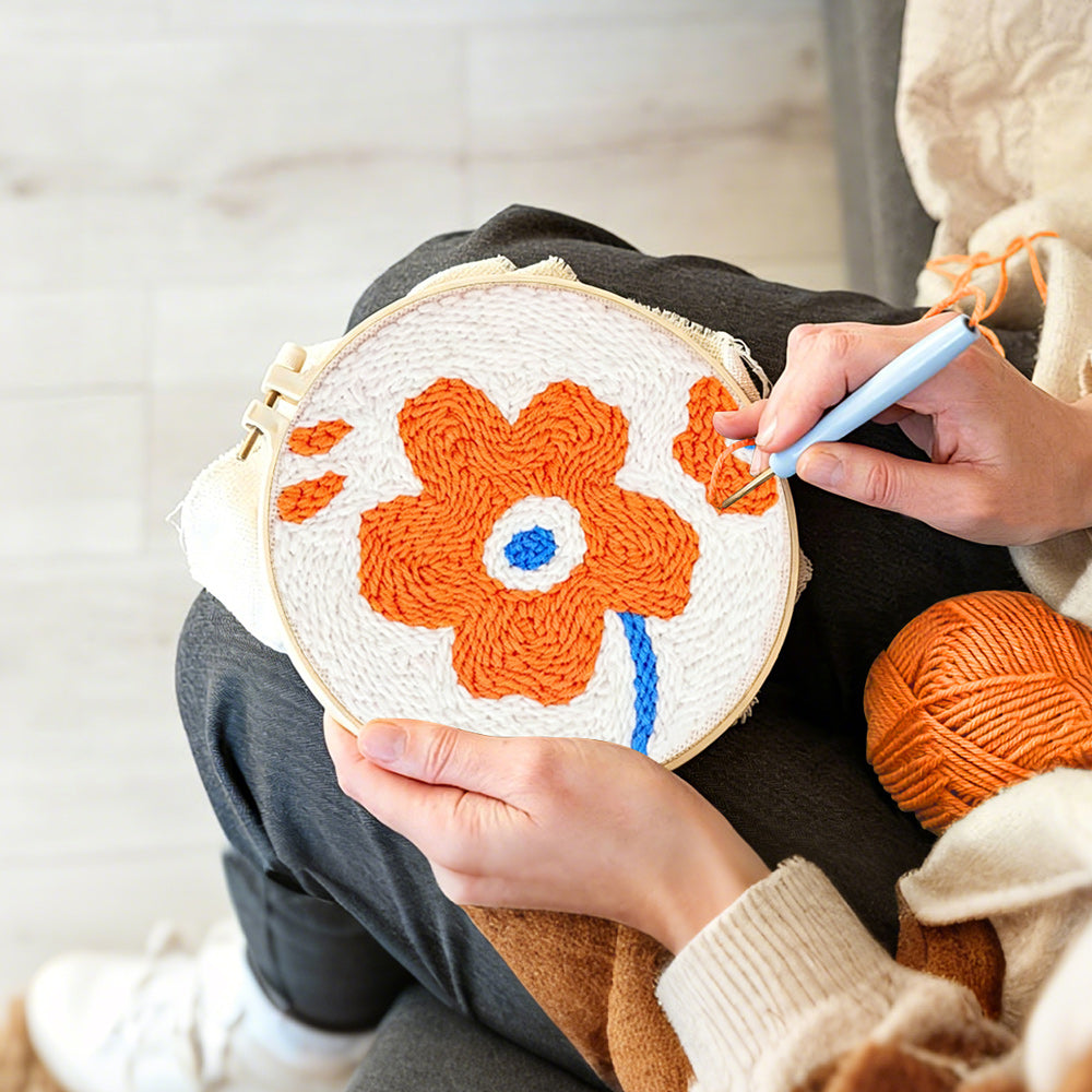 Creating handmade single orange flower punch needle artwork