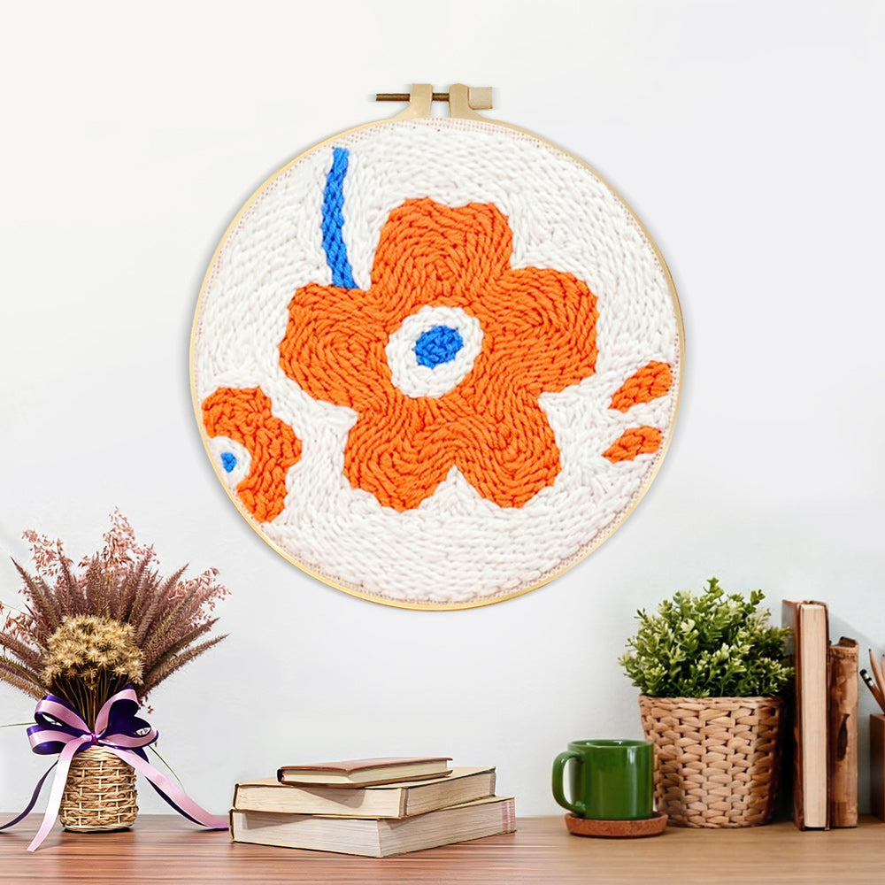 Finished single orange flower artwork displayed on a wall
