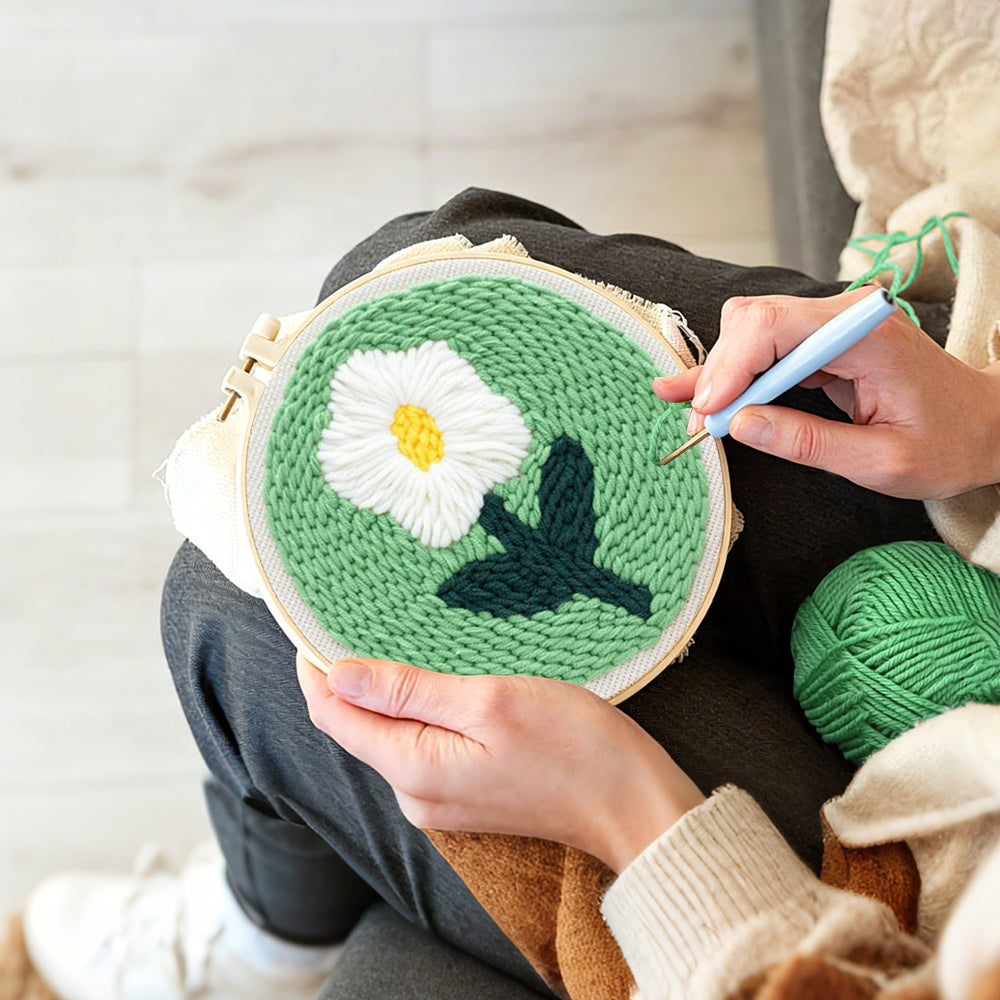 Creating handmade single white daisy punch needle artwork