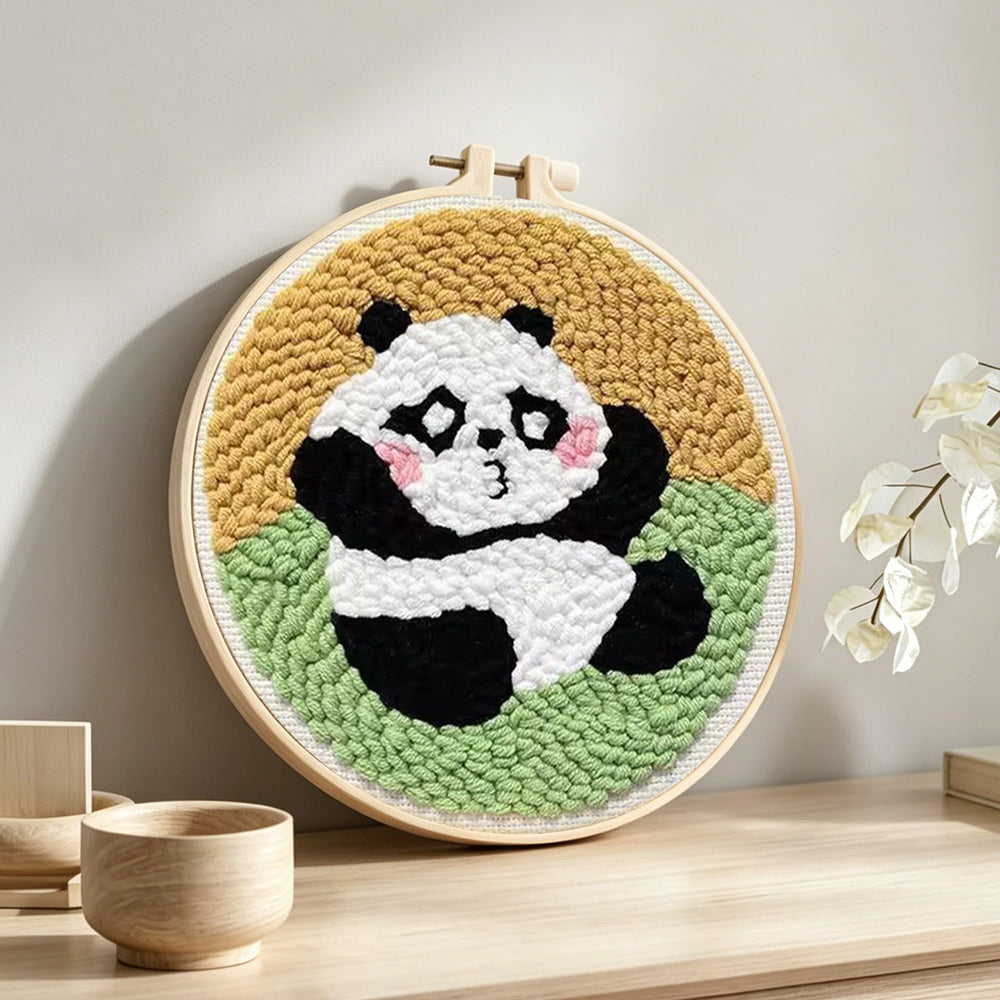 Sitting cute panda punch needle artwork displayed on a table
