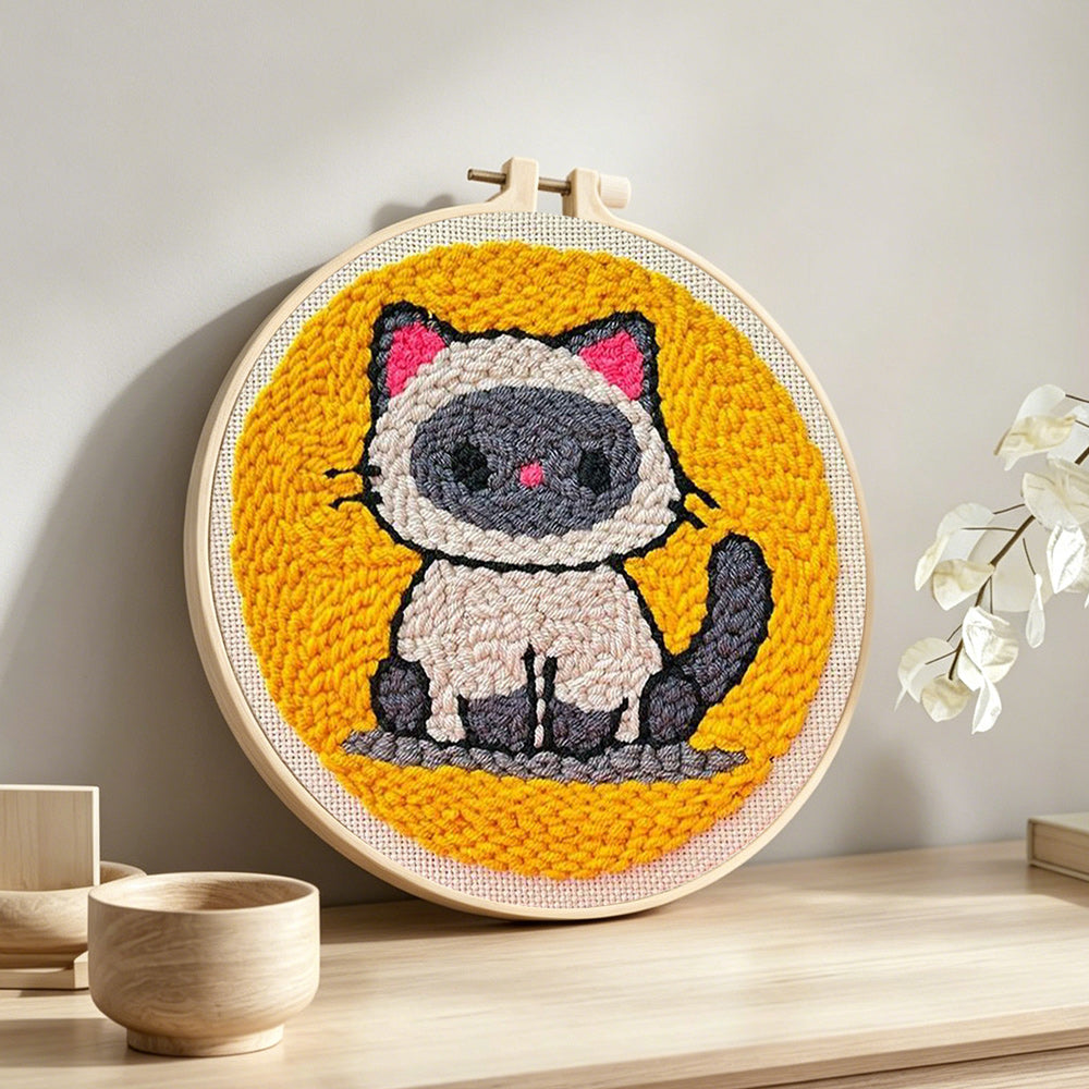 Sitting kitten punch needle artwork displayed on a table