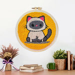 Finished sitting kitten artwork displayed on a wall