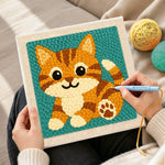 Creating handmade sitting orange tabby cat punch needle artwork