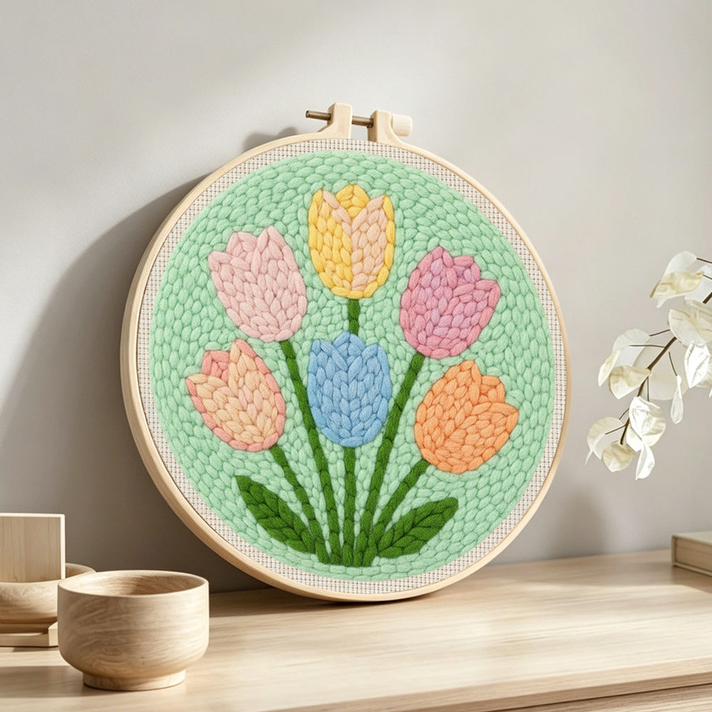 Six pastel tulips punch needle artwork displayed on a table