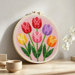 Six vibrant tulips punch needle artwork displayed on a table