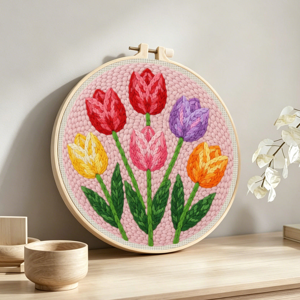 Six vibrant tulips punch needle artwork displayed on a table