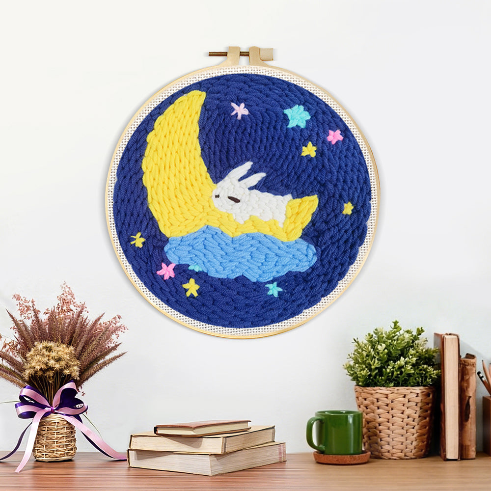 Finished sleeping bunny on crescent moon and stars artwork displayed on a wall