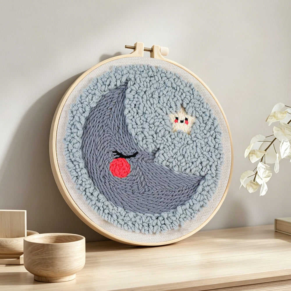 Sleeping crescent moon and star punch needle artwork displayed on a table