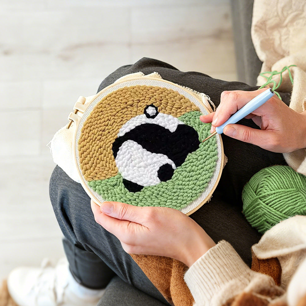 Creating handmade sleeping curled panda punch needle artwork