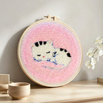 Sleeping kitten punch needle artwork displayed on a table