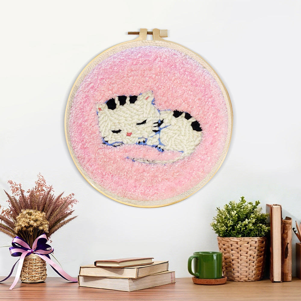 Finished sleeping kitten artwork displayed on a wall