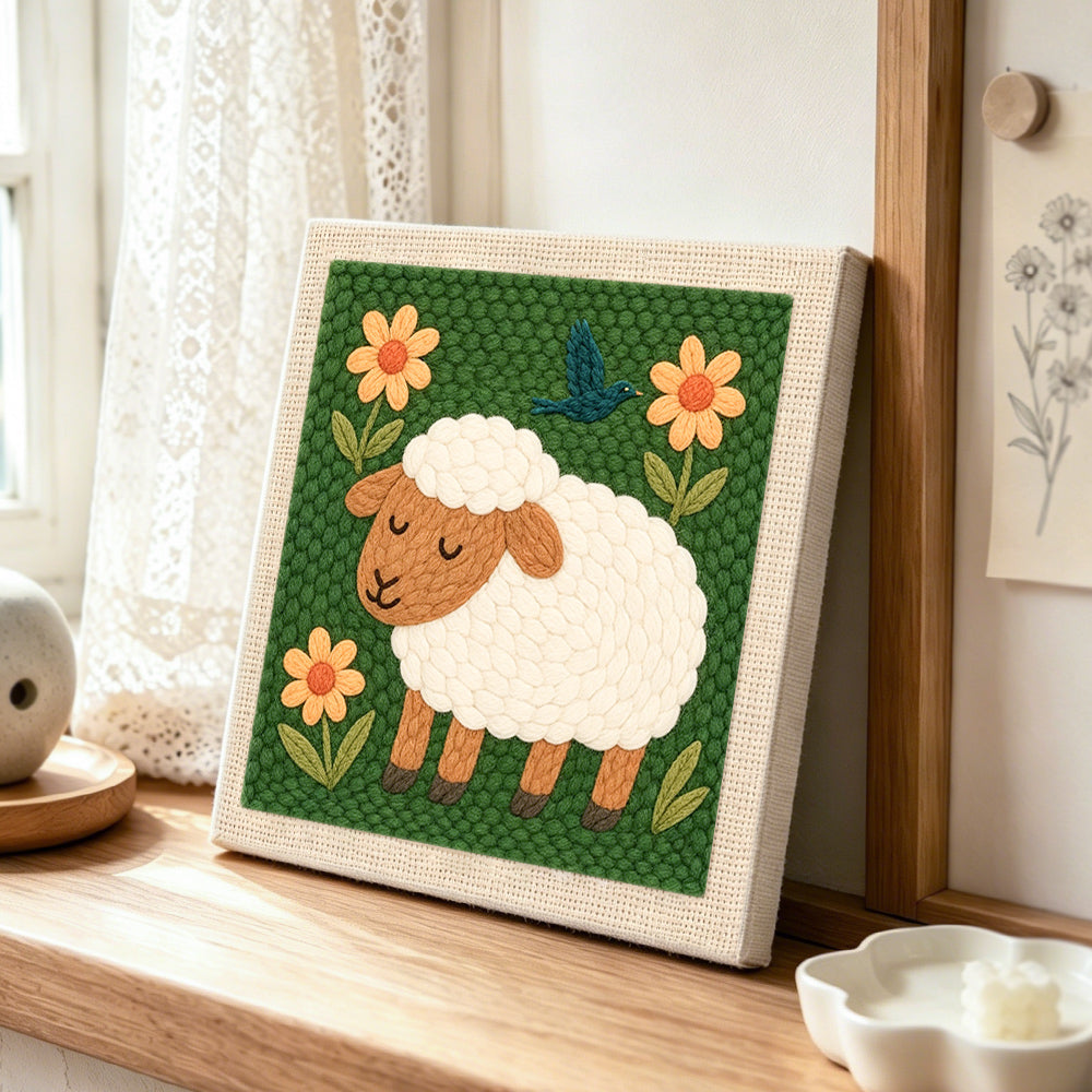 Sleeping sheep with flowers punch needle artwork displayed on a table