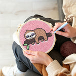 Creating handmade sleeping sloth on tree branch punch needle artwork