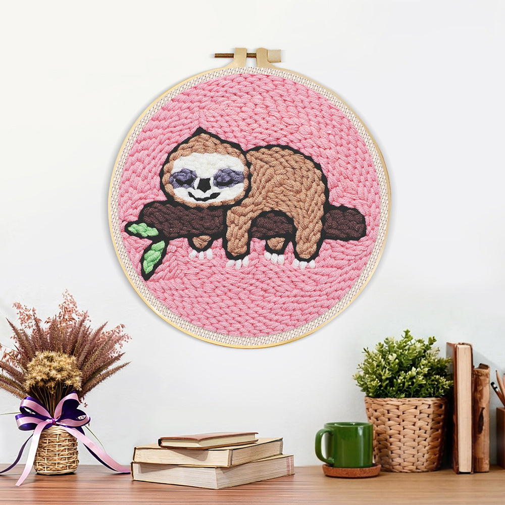 Finished sleeping sloth on tree branch artwork displayed on a wall