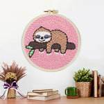 Finished sleeping sloth on tree branch artwork displayed on a wall