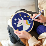 Creating handmade sleeping unicorn under stars punch needle artwork