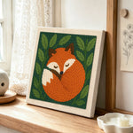Sleeping woodland fox punch needle artwork displayed on a table