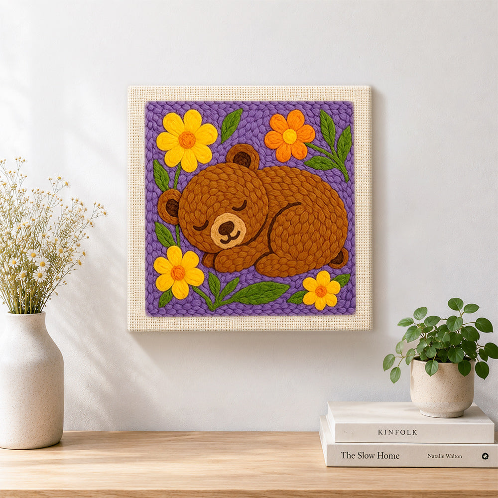 Finished sleepy bear with flowers artwork displayed on a wall