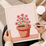 Creating handmade small pink flowers in pot punch needle artwork