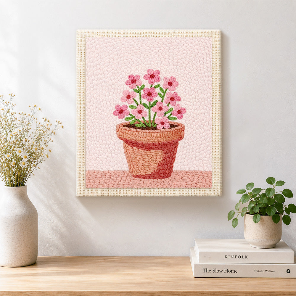 Finished small pink flowers in pot artwork displayed on a wall