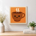 Finished smiley face coffee cup artwork displayed on a wall