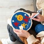 Creating handmade smiley orange with "best of luck" text punch needle artwork