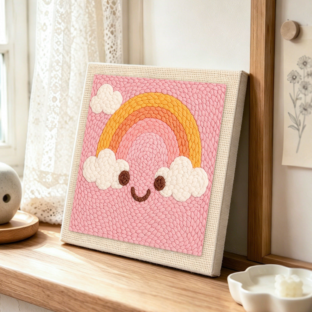 Smiley rainbow punch needle artwork displayed on a table