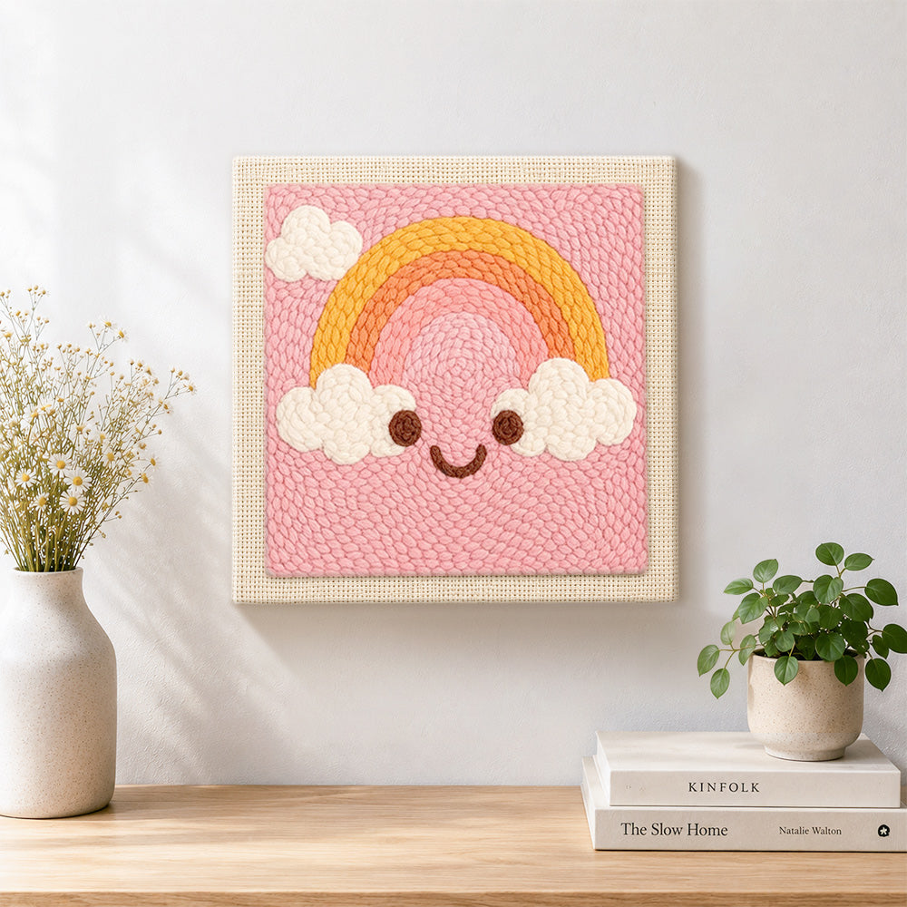 Finished smiley rainbow artwork displayed on a wall