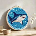 Smiling deep-sea shark punch needle artwork displayed on a table