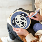 Creating handmade smiling dog punch needle artwork