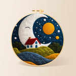 Smiling giant moon and little red cottage needle felting kit for beginners with a round wooden frame