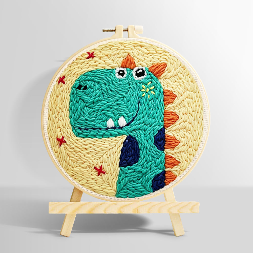 Smiling green dinosaur punch needle kit for beginners