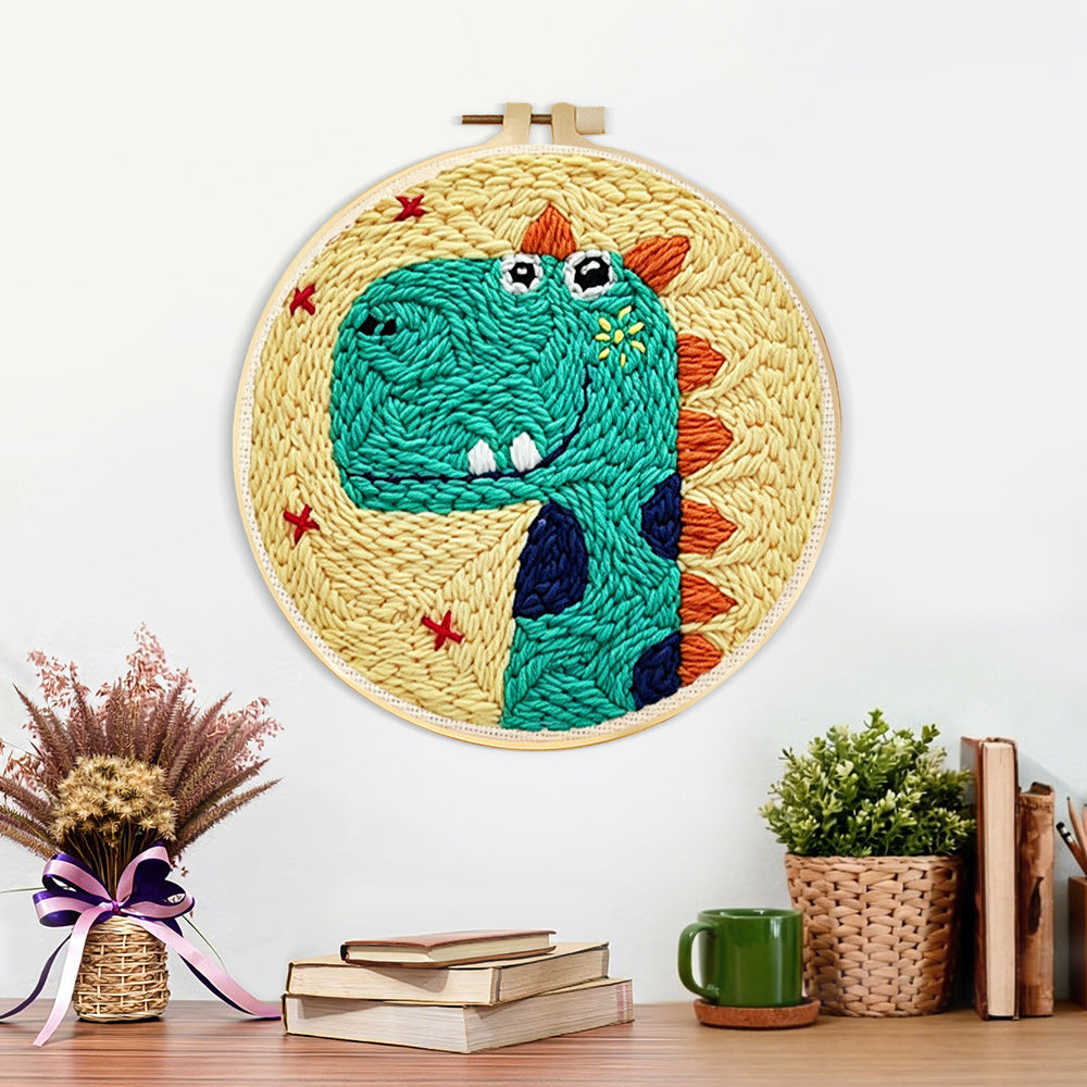 Finished smiling green dinosaur artwork displayed on a wall