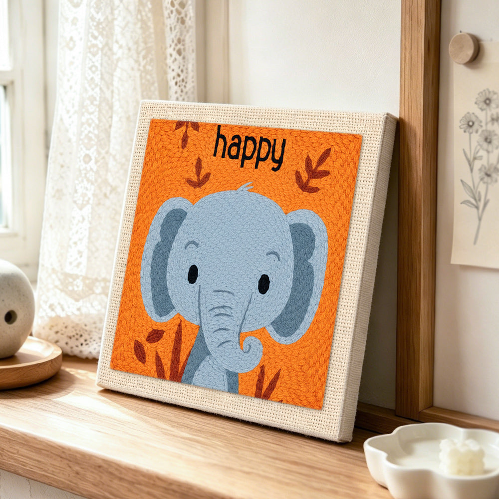 Smiling grey elephant punch needle artwork displayed on a table