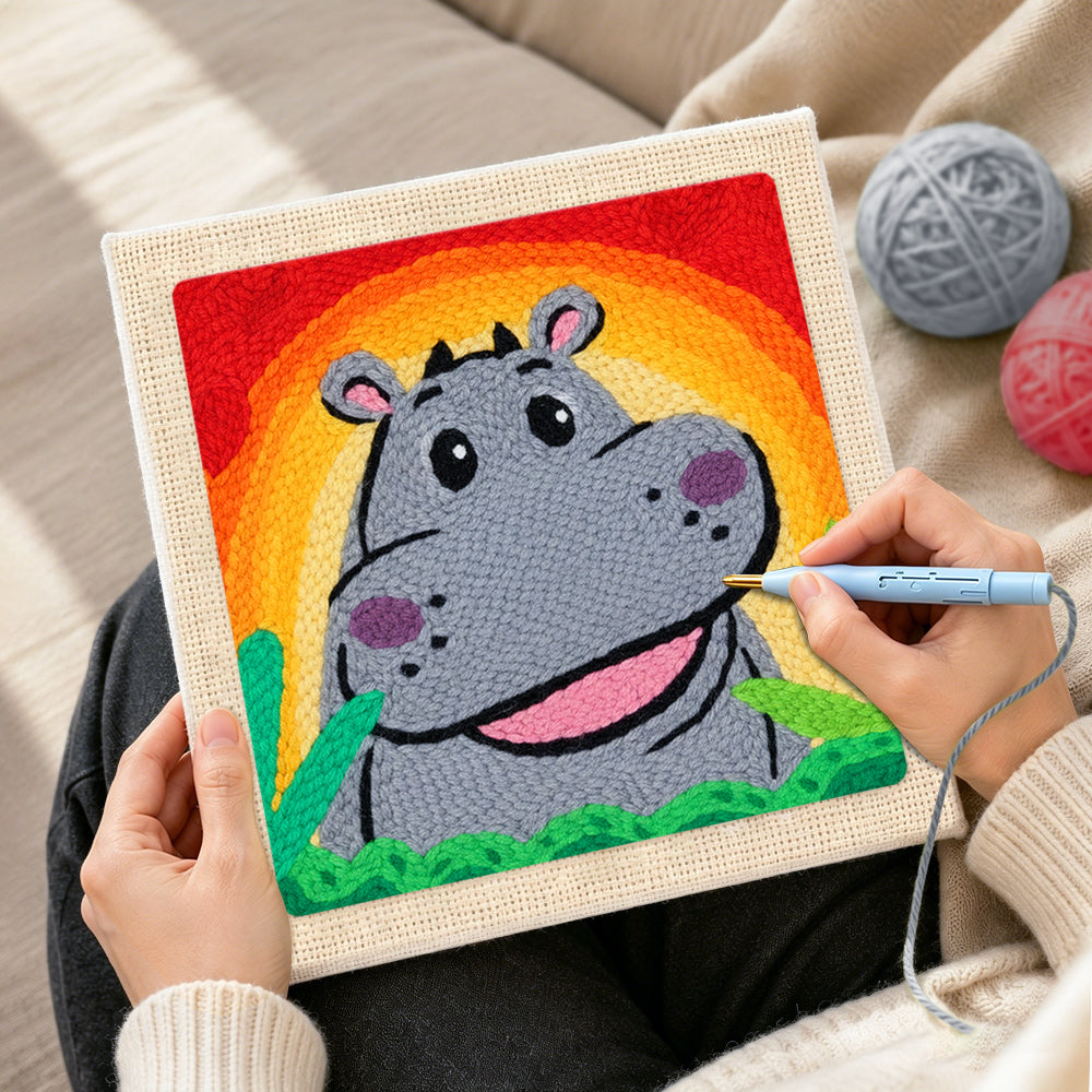 Creating handmade smiling grey hippo with rainbow sunset punch needle artwork