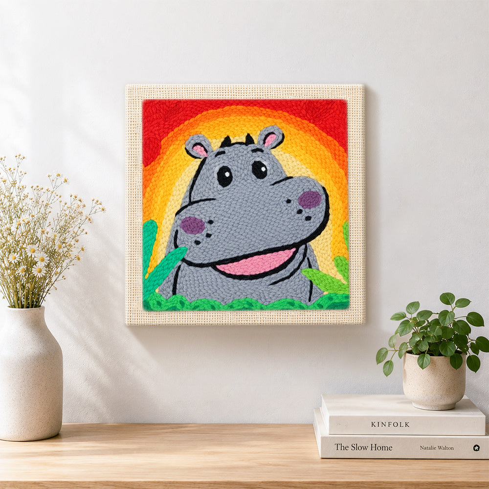 Finished smiling grey hippo with rainbow sunset artwork displayed on a wall