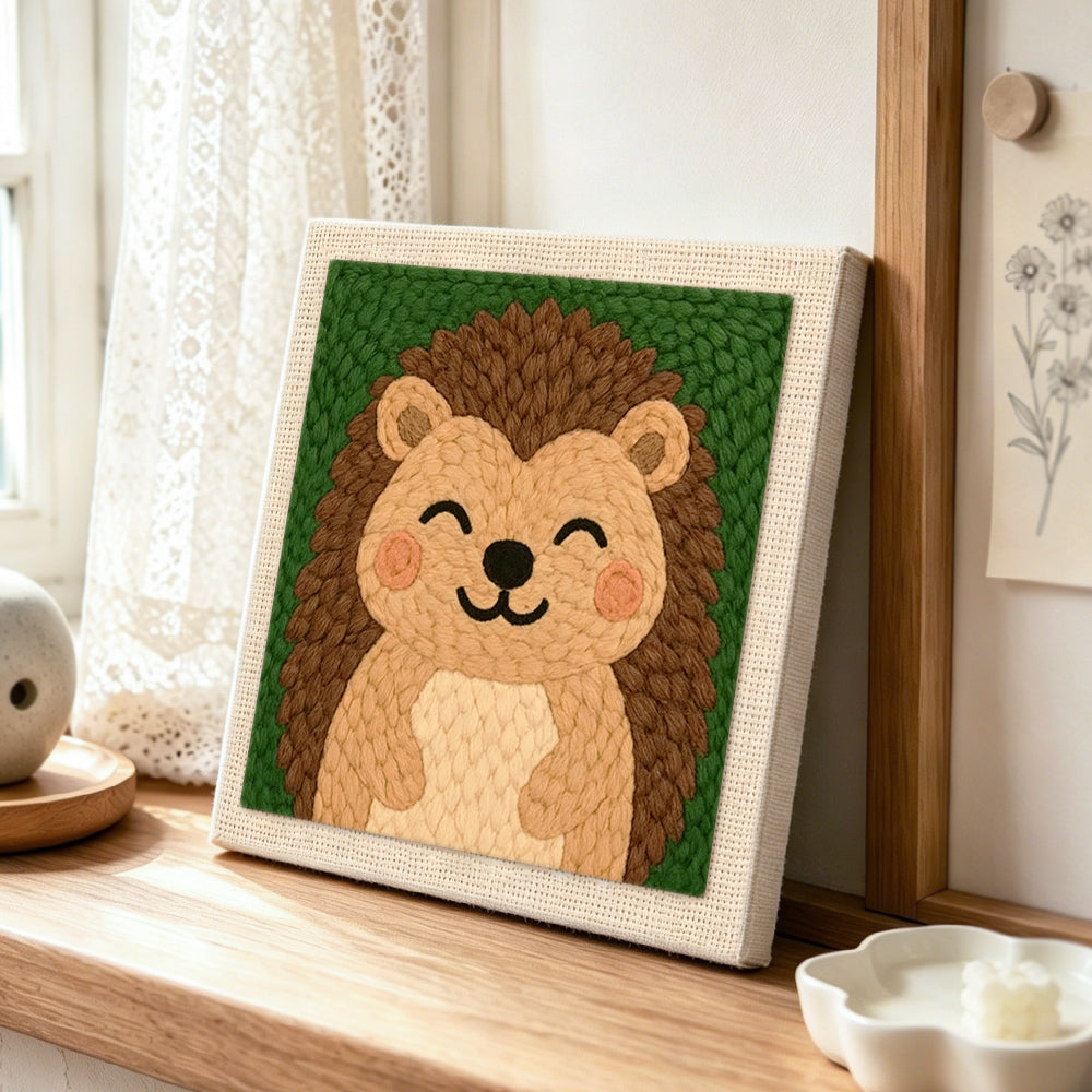 Smiling hedgehog punch needle artwork displayed on a table