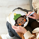 Creating handmade smiling little monkey punch needle artwork