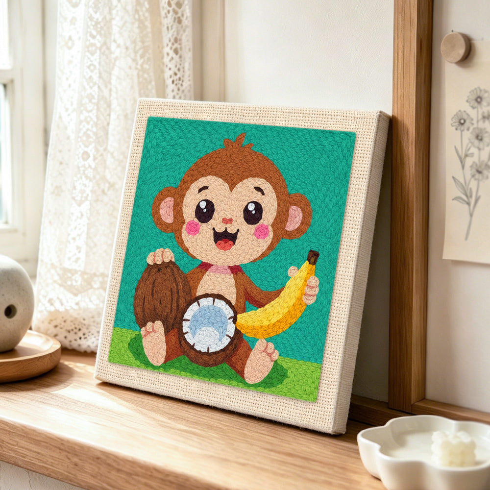 Smiling monkey with coconut and banana punch needle artwork displayed on a table