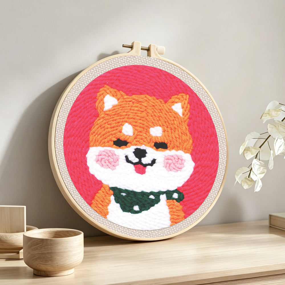 Smiling shiba inu punch needle artwork displayed on a table