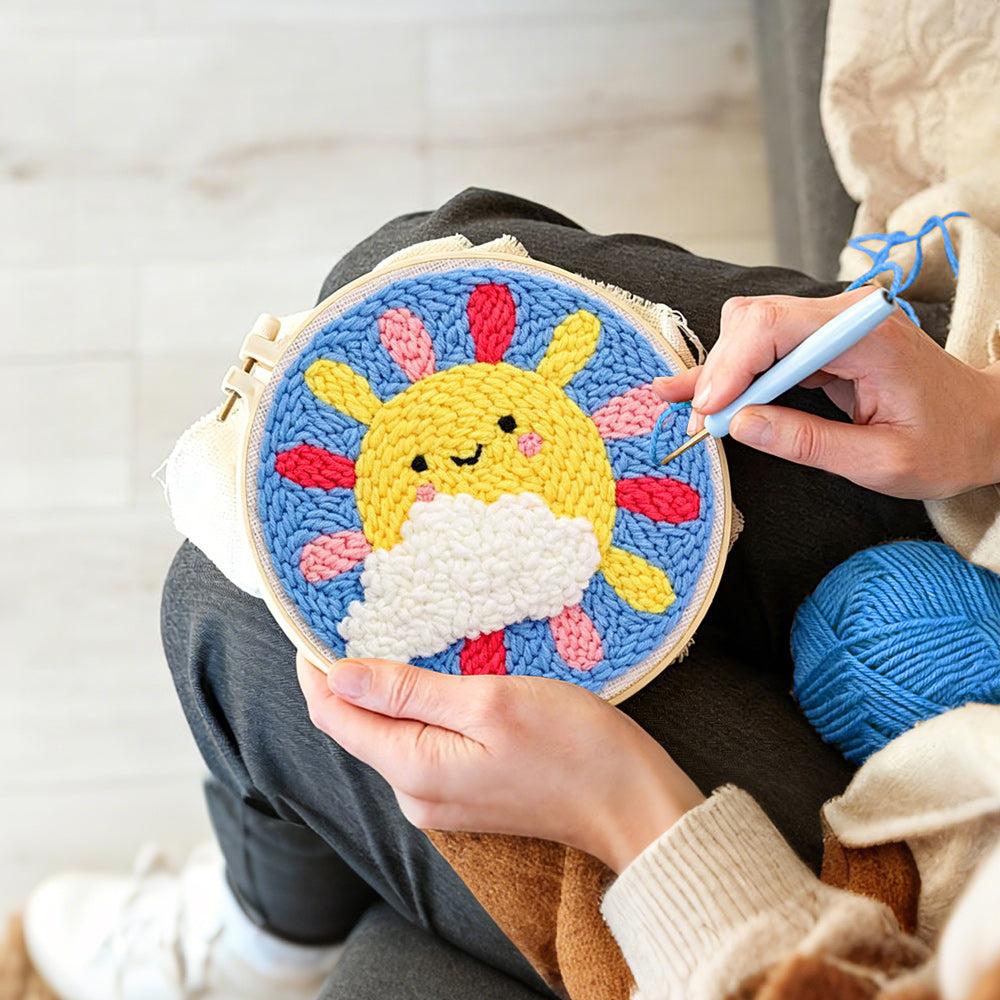 Creating handmade smiling sun with rainbow rays punch needle artwork