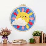 Finished smiling sun with rainbow rays artwork displayed on a wall