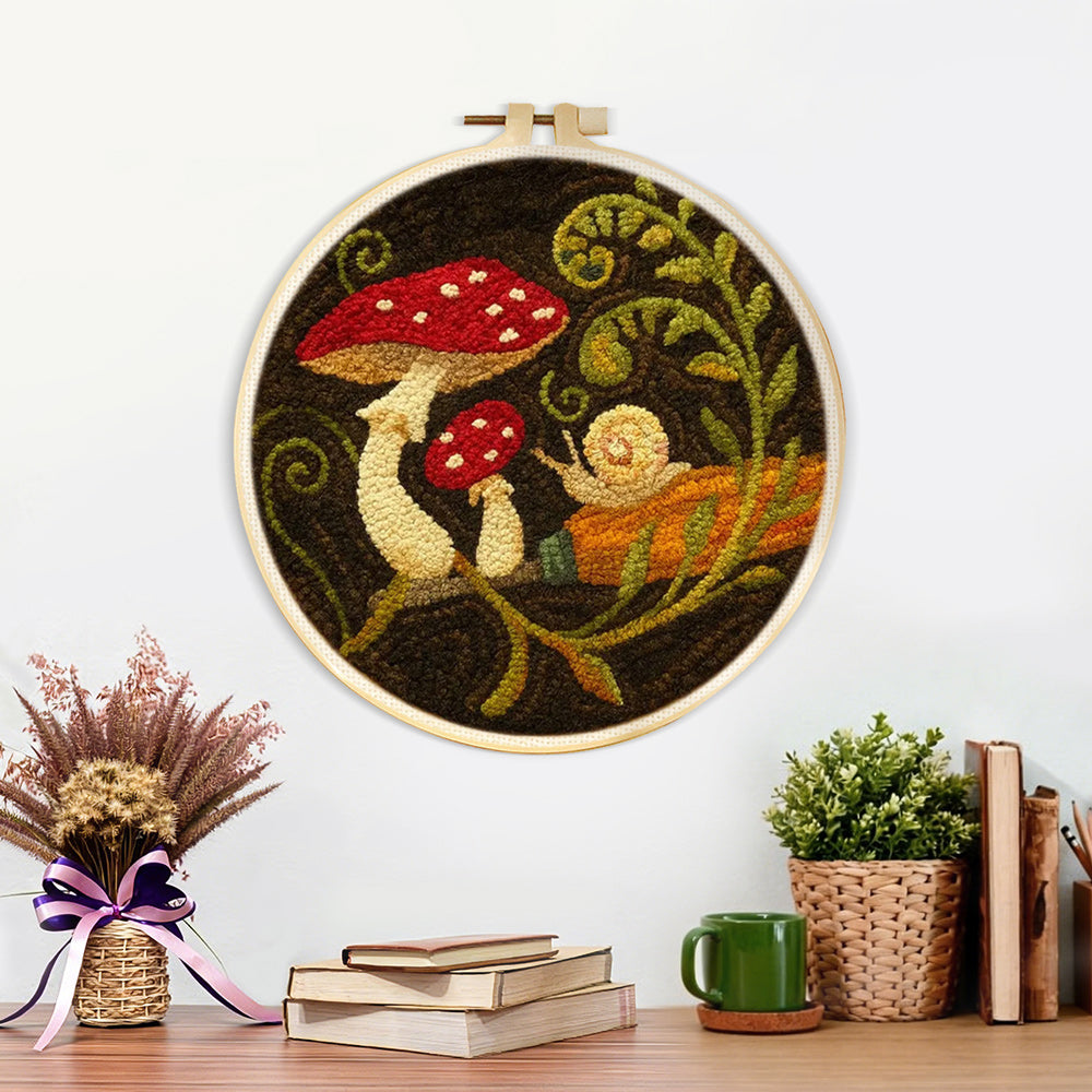 Finished snail and mushroom artwork displayed on a wall