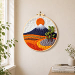 Snow-capped mountain at sunrise needle felt wall art displayed in a bright home interior