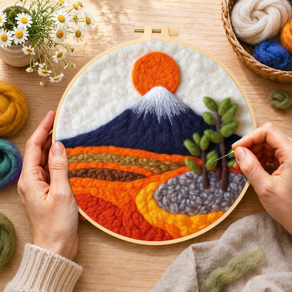 Creating the snow-capped mountain at sunrise wool painting by hand with a felting needle