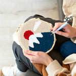 Creating handmade snow-capped mountain at sunrise punch needle artwork