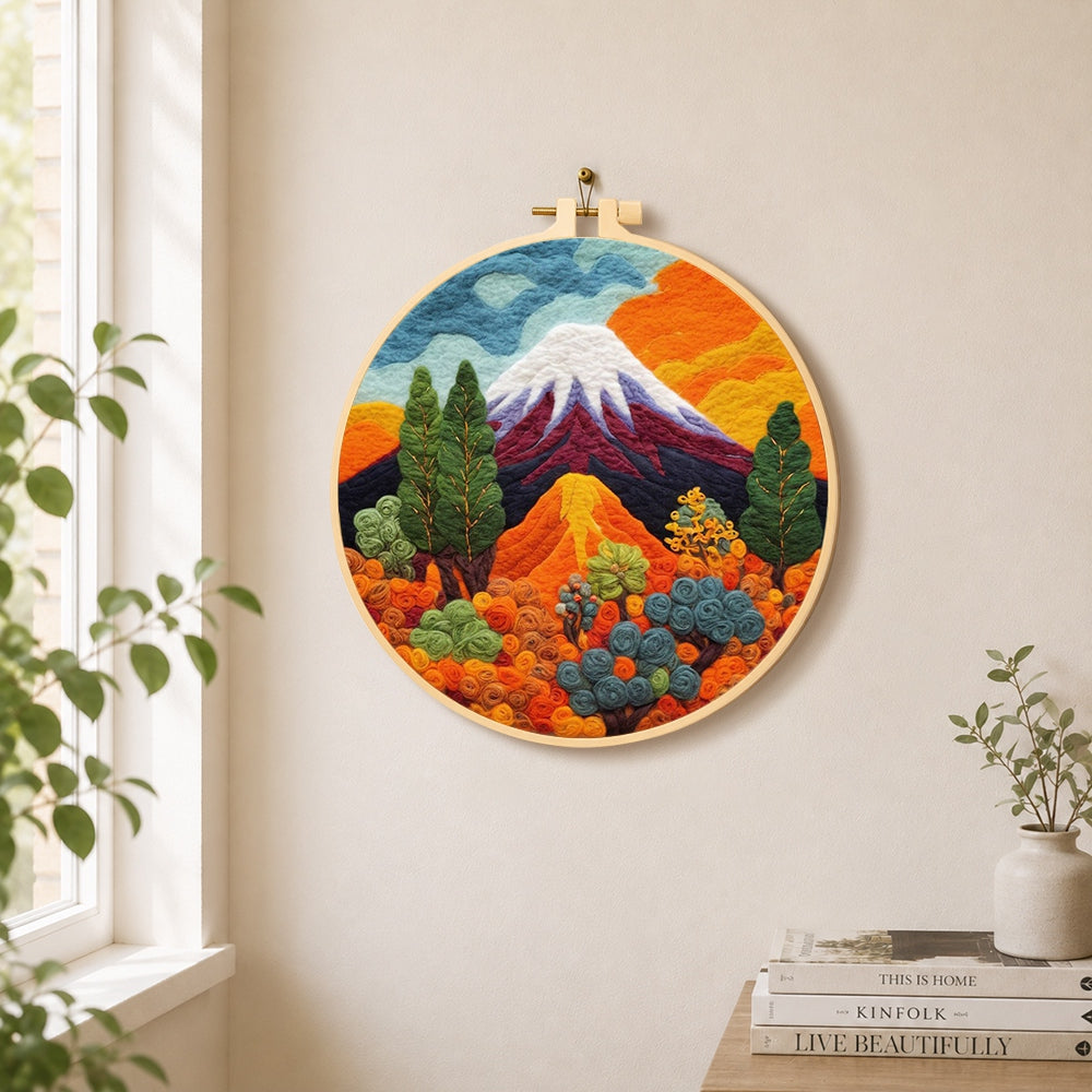 Snow-capped volcano and lush plants needle felt wall art displayed in a bright home interior