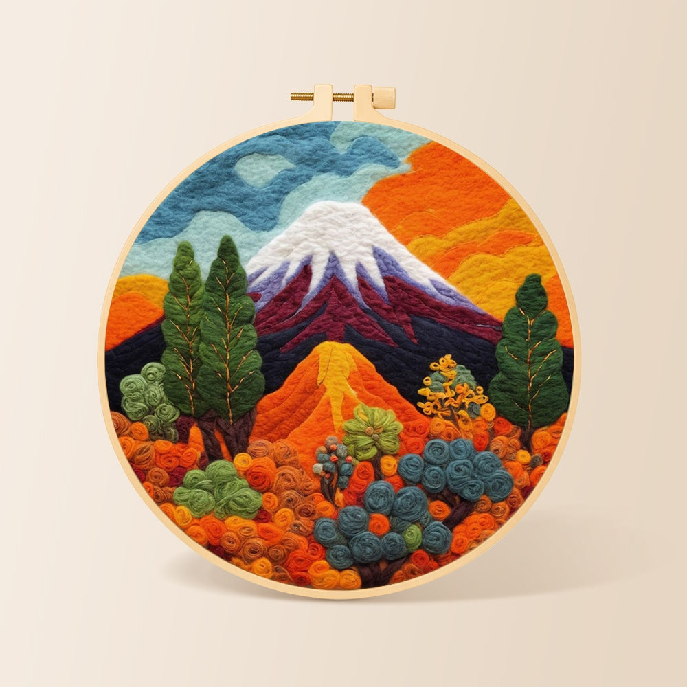Snowcapped volcano and lush plants needle felting kit for beginners with a round wooden frame