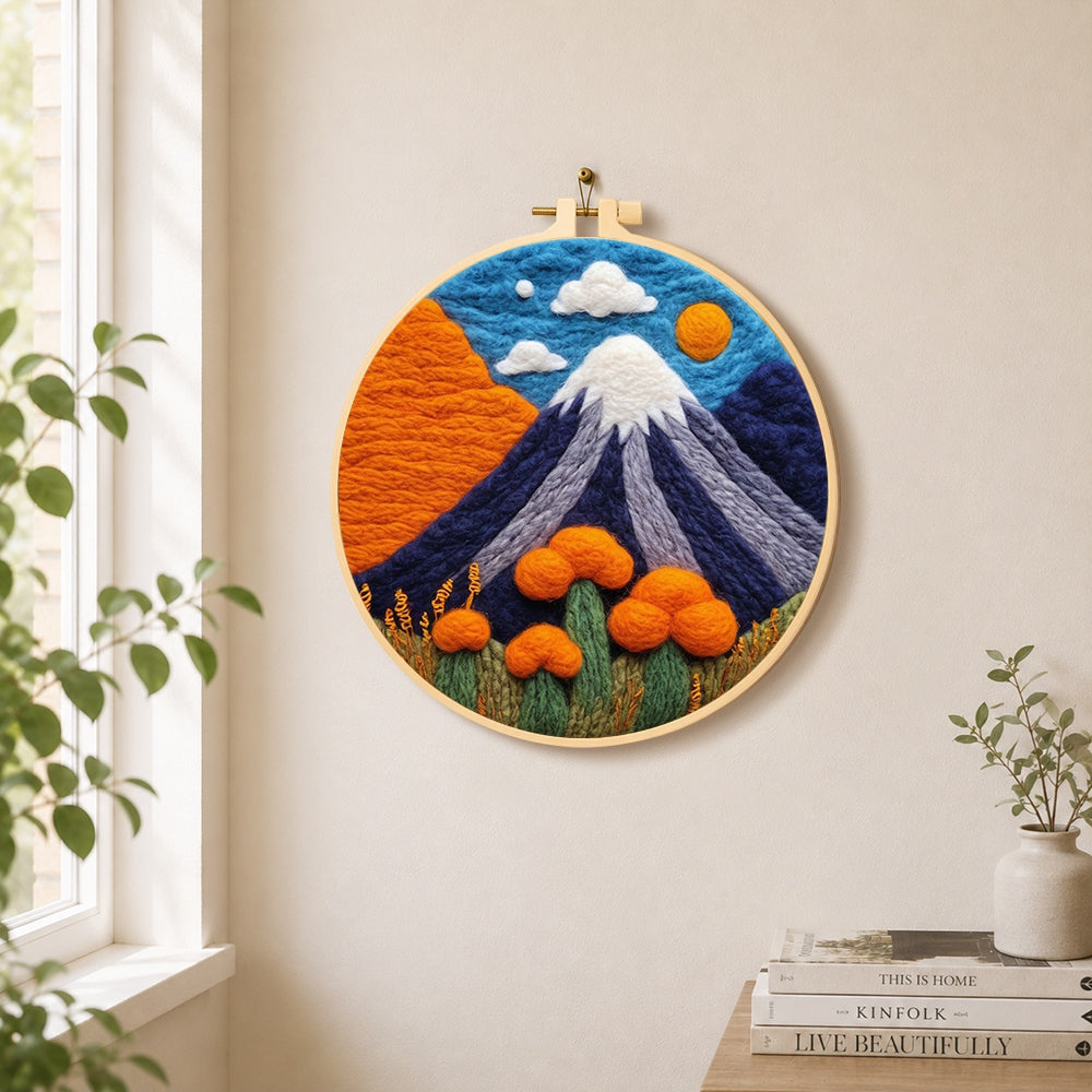 Snow-capped volcano needle felt wall art displayed in a bright home interior