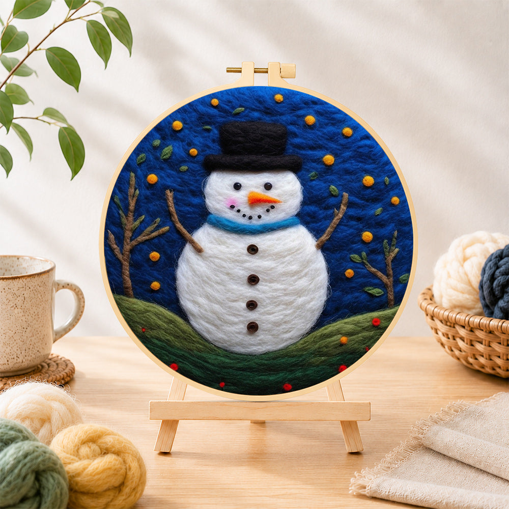Finished snowman under the starry blue night needle felting displayed on a wooden easel